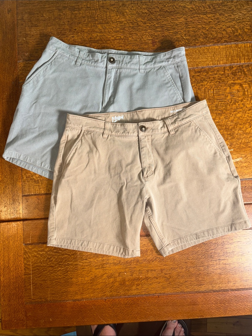 2 pairs of Mugsy Casual Chino Shorts in Tan and Light Gray. Size 34.